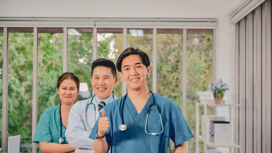 Team of smiling healthcare professionals in a clinic setting demonstrating successful clinic management.